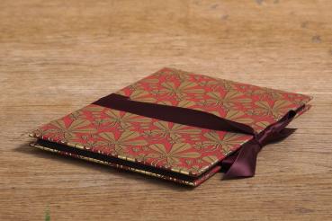 Leporello with red Florentine paper and golden maple leaf, red ribbon